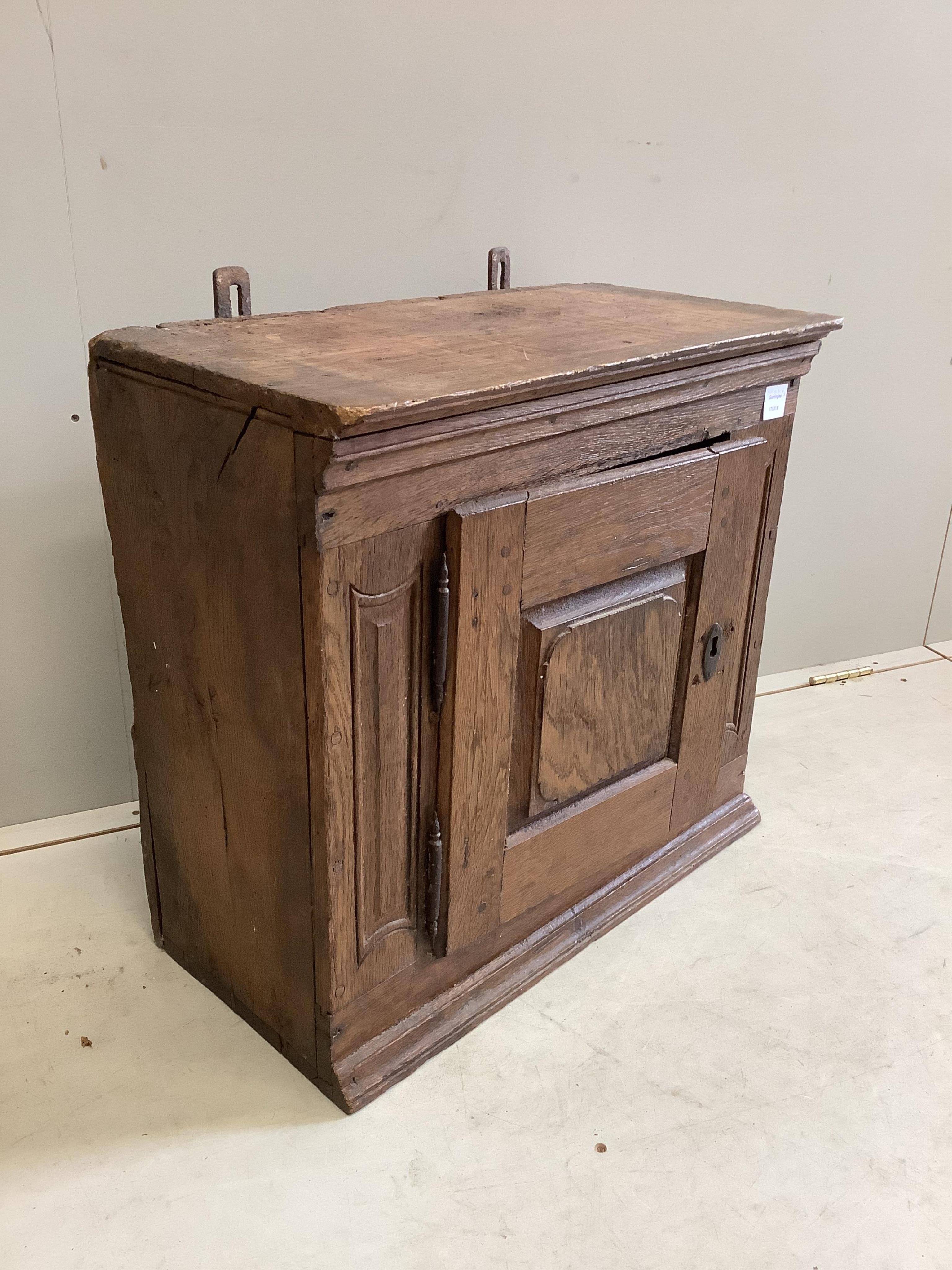 A small oak cupboard, width 61cm, depth 32cm, height 58cm